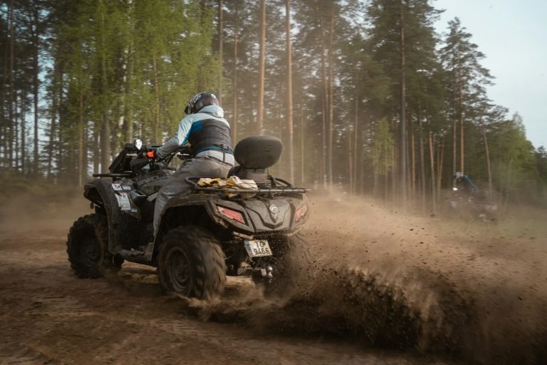 Riding an ATV on a dirt track