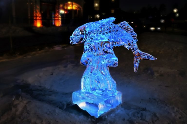 Glowing blue ice sculpture of a fish