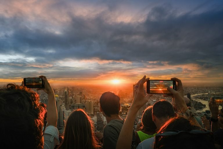 Visitors on a skyscraper rooftop deck